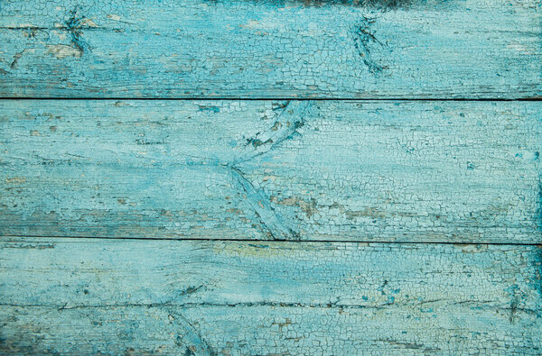 Old weathered wood plank painted in blue.