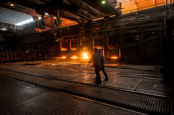 Steelworkers near the working open hearth furnace