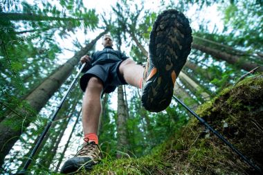 Gezgin içinde yürüyüş ayakkabıları trekking Polonyalılar ile ormanda yürür