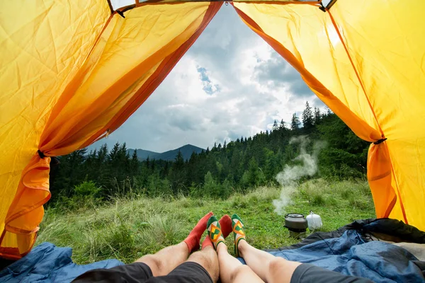 Legs of a couples of man and woman in a tent outdoors — Stock Photo, Image