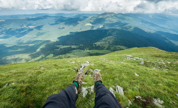 Benen van de reiziger in wandelschoenen in de bergen — Stockfoto