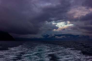 Fırtınalı bulutlar ve azgın dalgalar kışın fırtınalı bir gecede denizde..