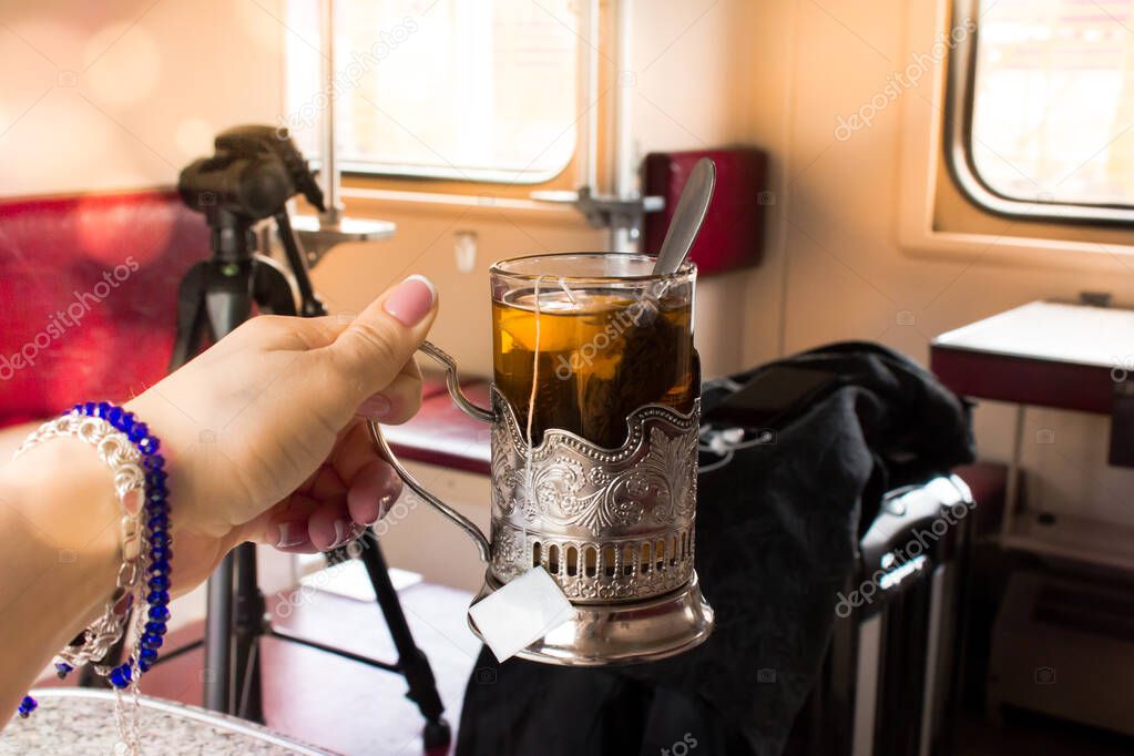 Glass with a metal cup holder. Tea in the Russian train.