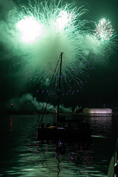 Close-up photo of a firework at night in the sea. Fireworks for the holiday. Background.