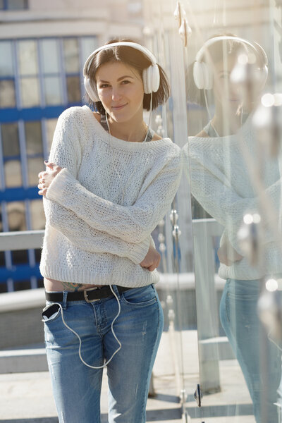 Woman in white earphones listen music outdoor