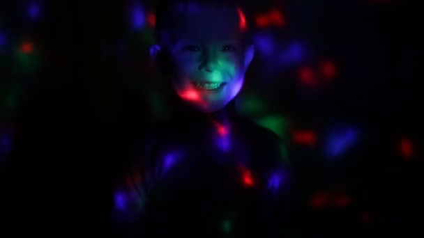 Disco light lamp on a little boy — Stockvideo