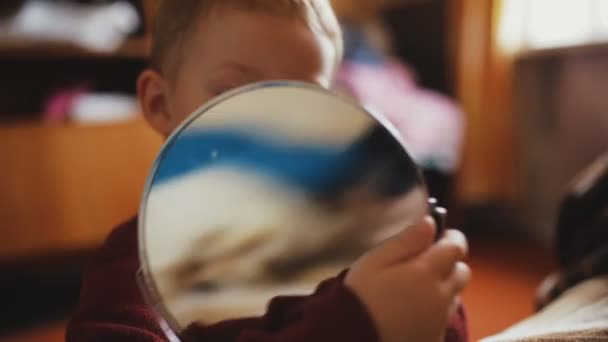 Boy playing with mirror in home room — Stock Video