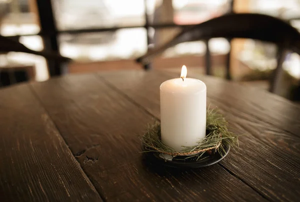 Still life - candle burning on a brown table in cafe — Stock Photo, Image