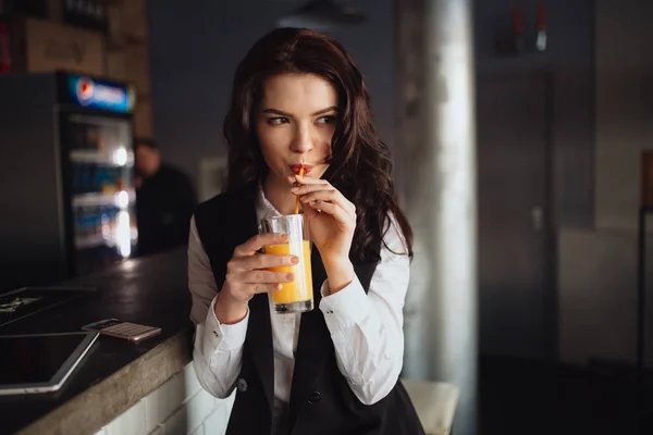 Note di alimentazione - giovane donna che beve succo d'arancia al bar del ristorante — Foto Stock