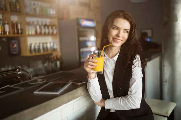 Healthy eating - young woman drinking orange juice at restaurant bar — Stock Photo, Image