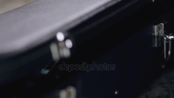 Closeup of guitarist gets a guitar out of the case — Stock Video