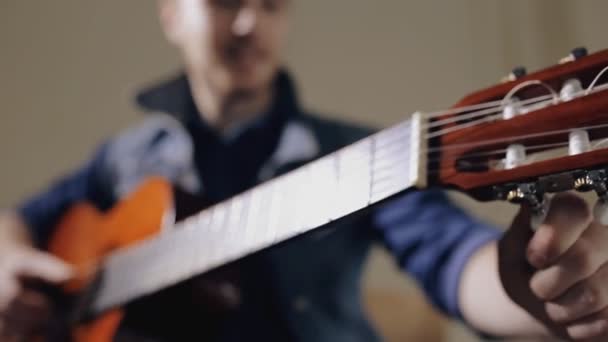 Guitarrista afinando la guitarra acústica — Vídeos de Stock