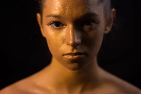 Creative art makeup - bronze woman face closeup