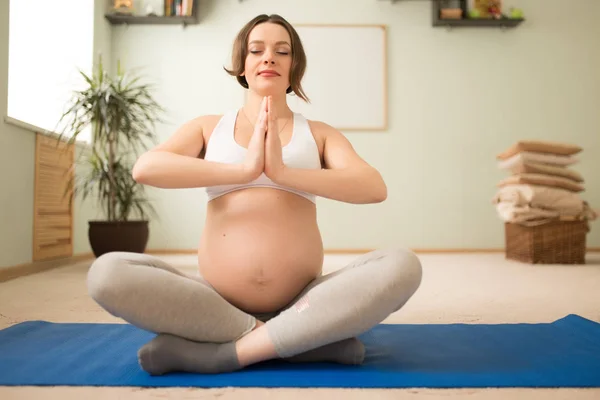 Kobieta w ciąży się lotus jogi ćwiczenia — Zdjęcie stockowe