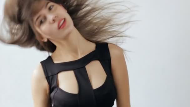 Приваблива жінка кидає волосся на білому тлі, повільний рух — стокове відео
