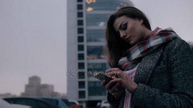 Şehir merkezinde akıllı telefon isteyen genç kadın