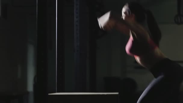 Sport woman jump on a box in gym — Stock Video