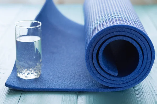 Sportive mat and water in glass