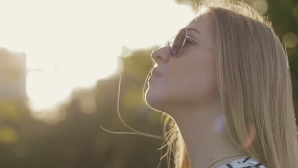 Closeup portrait of teenager girl standing in a park — Stock Video