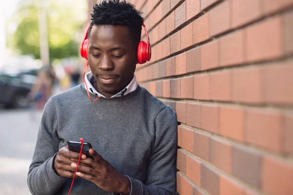 African american man listen music in city