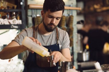 Genç erkek barmen bir alkol kokteyl hazırlama