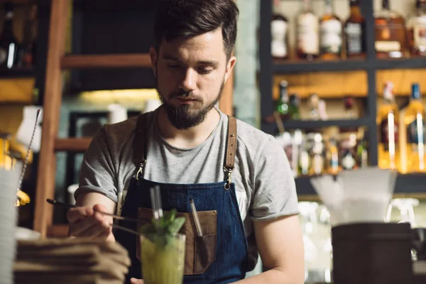 Mladý muž barman připravuje koktejl alkoholu — Stock fotografie