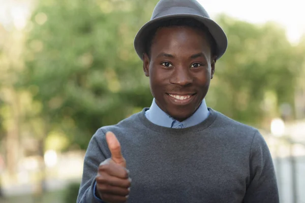 African american man in hat giving thumbs up