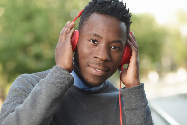 African american man listen music in city