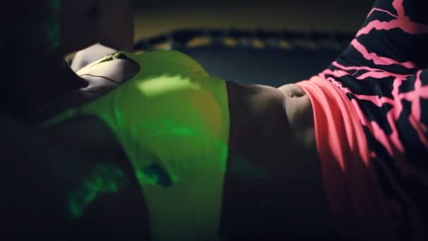 Pretty sports woman pumping press muscle on rebounder in dark gym — Stock Footage Pretty sports woman pumping press muscle on rebounder in dark gym Royalty Free Stock Footage