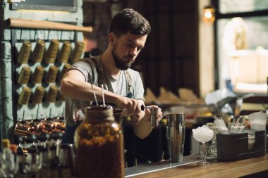 Genç erkek barmen bir alkol kokteyl hazırlama