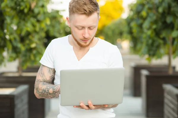 Man freelancer working with laptop outdoors