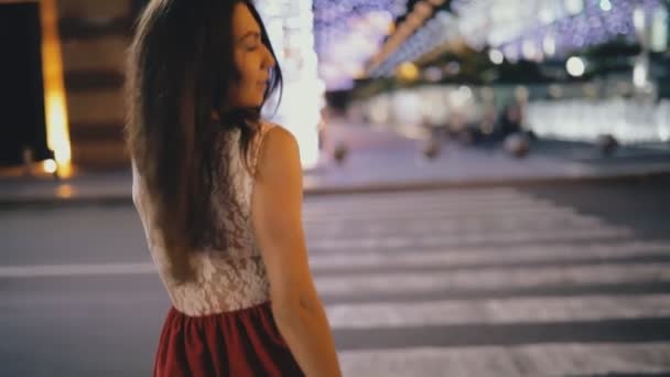 Спокуслива жінка в красивій сукні, що йде на нічній міській вулиці — стокове відео