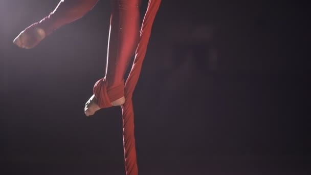 Legs closeup of female aerial gymnast performing on a red silk — Stock Video