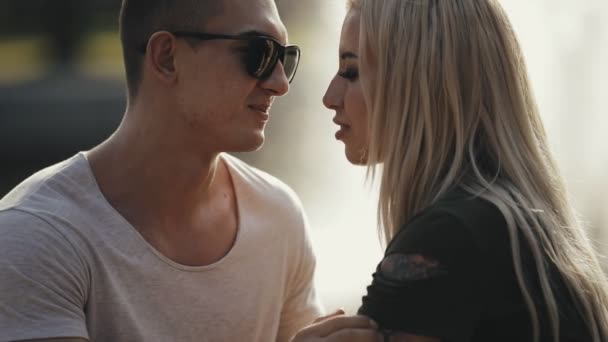 Tenderness of young loving couple against a fountain background — Stock Video