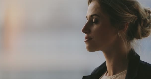 Portrait of young woman in classical suit turn face in high floor balcony — Stock Video