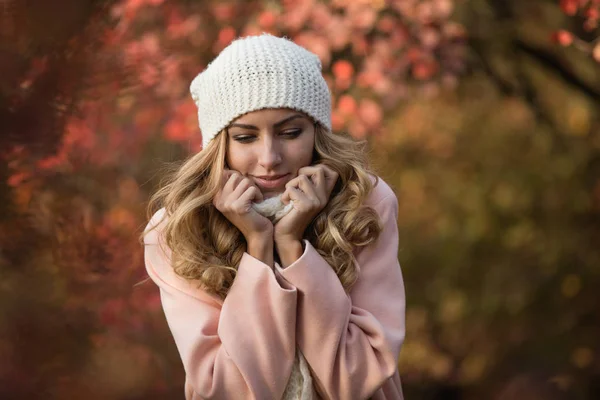 Retrato de mujer bonita en sombrero blanco en el día de otoño, ella de pie en el parque, follaje colorido alrededor —  Fotos de Stock