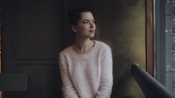 Girl looking at window in cafe — Stock Video