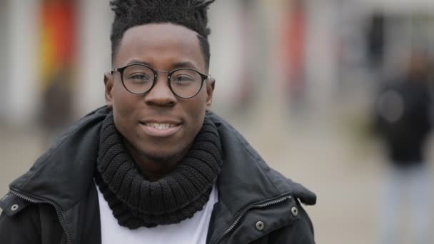 Retrato sonriente del hombre africano en la calle de la ciudad, otoño frío — Vídeos de Stock