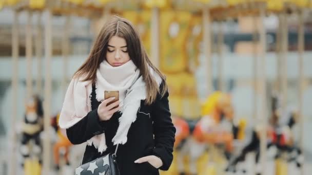 Woman using smartphone at winter city — Stock Video