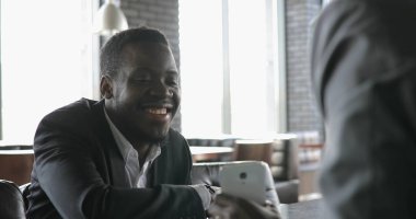 Kafede, konuşan Afrika adam arkadaşlar gösterir Fotoğraflar akıllı telefon