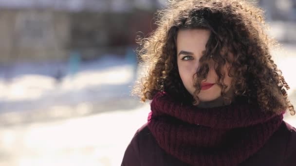 Happy smiling curly hair woman close up portrait in snowy day, slowmotion — Stock Video