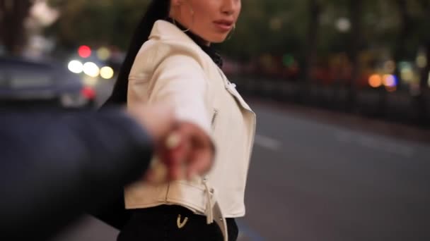 Pov, young couple holding hands, woman leading boyfriend through city street — 图库视频影像