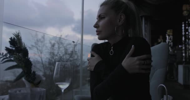 Woman drinking white wine in restaurant with sea view — 비디오