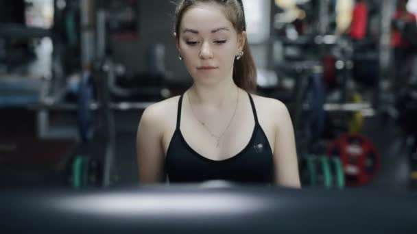 Young woman going on a treadmill — 비디오