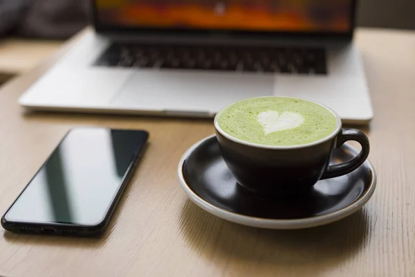 Workplace with matcha latte — ストック写真