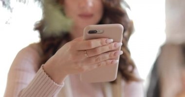 Woman messaging in cafe