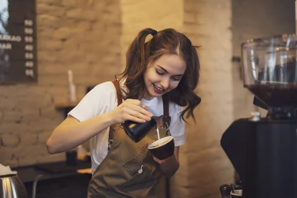 Barista woman make a coffee in the cafeteria