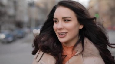 Smiling pretty woman portrait in city