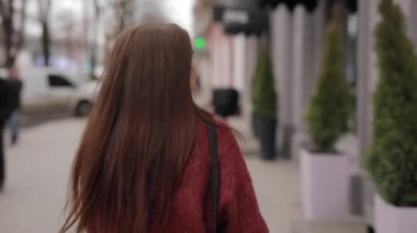 Fashion woman walking in city turning face