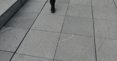 Female legs going on pavement